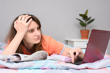 Image showing Tired upset girl trying to find a suitable job