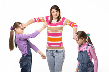 Image showing Girl trying to separate the fighting children, isolated on white background