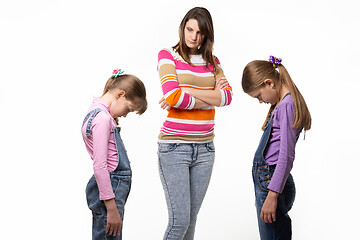 Image showing The girls are ashamed in front of their mother, their mother scolds them