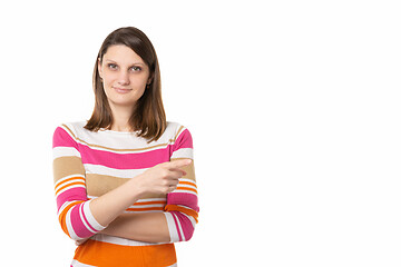 Image showing Portrait of a beautiful girl of thirty years of European appearance on a white background, the girl points a finger to an empty place