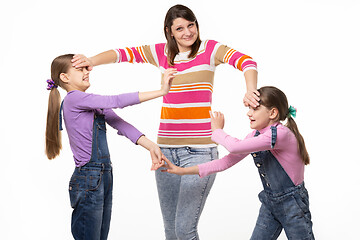 Image showing A woman cannot calm two fighting girls