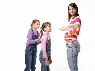 Image showing The girl begs the toy from her mother, mother wearily points a finger at the child