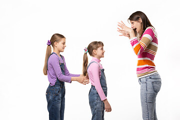 Image showing Mom scares her two daughters, isolated on white background