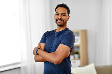 Image showing smiling indian man with fitness tracker at home