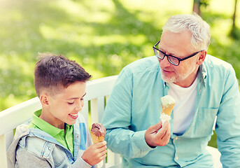 Image showing old man and boy eating ice cream at summer park