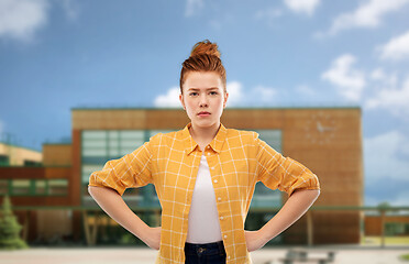 Image showing serious red haired teenage girl with hands on hips