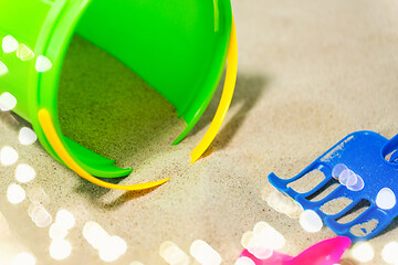 Image showing close up of bucket and rake on beach sand