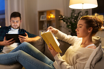Image showing couple with tablet computer and book at home