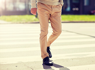 Image showing senior man walking along city crosswalk