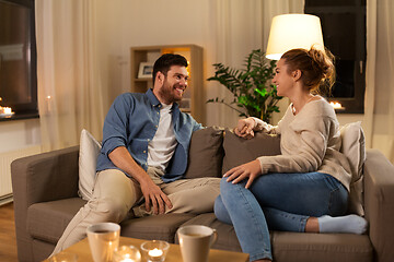 Image showing happy couple talking at home in evening