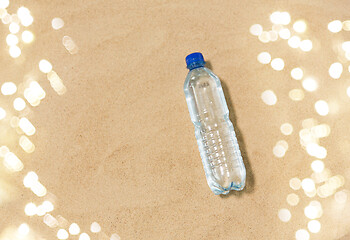 Image showing bottle of water on beach sand