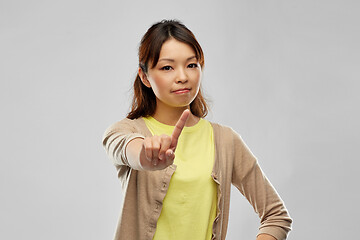 Image showing young asian woman threatening with finger