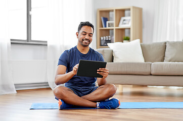 Image showing indian man with tablet pc and exercise mat at home