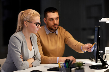 Image showing business team with computer working late at office