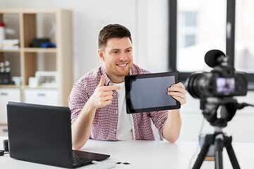 Image showing male blogger with tablet pc videoblogging at home