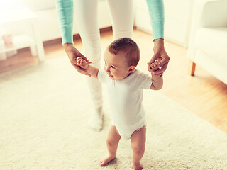 Image showing happy baby learning to walk with mother help