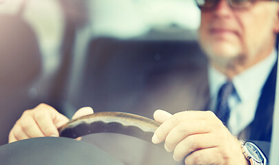 Image showing senior businessman hands driving car