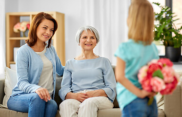 Image showing grandmother, mother and daughter with flowers