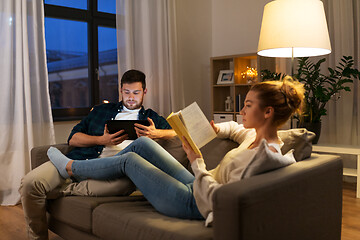 Image showing couple with tablet computer and book at home