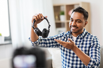 Image showing male blogger with headphones videoblogging at home