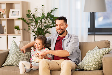 Image showing happy father and daughter watching tv at home