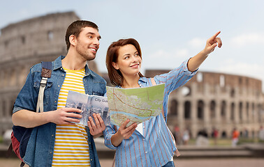 Image showing happy couple of tourists with city guide and map