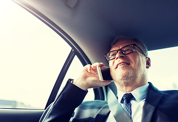 Image showing senior businessman calling on smartphone in car