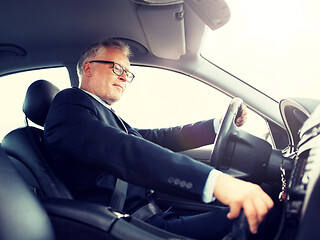 Image showing happy senior businessman driving car