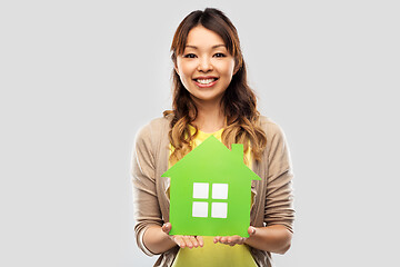 Image showing happy asian woman with green house