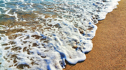 Image showing Sea water with white foam in the coastal sand