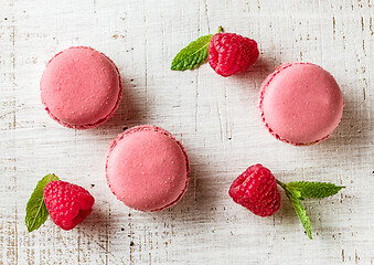 Image showing pink macaroons on wooden table