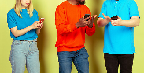 Image showing Group of friends using mobile smartphones. Teenagers addiction to new technology trends. Close up.