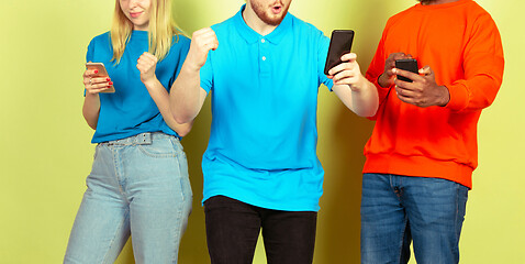 Image showing Group of friends using mobile smartphones. Teenagers addiction to new technology trends. Close up.