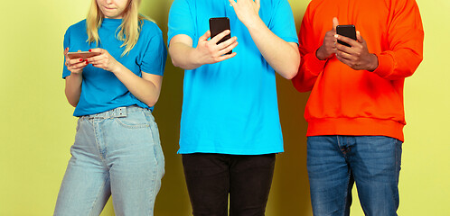 Image showing Group of friends using mobile smartphones. Teenagers addiction to new technology trends. Close up.