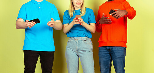 Image showing Group of friends using mobile smartphones. Teenagers addiction to new technology trends. Close up.