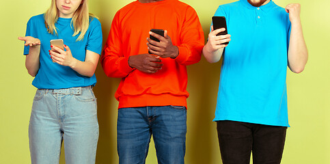 Image showing Group of friends using mobile smartphones. Teenagers addiction to new technology trends. Close up.