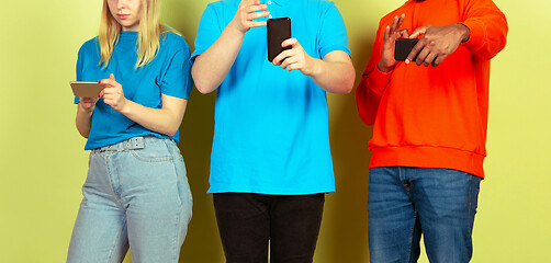 Image showing Group of friends using mobile smartphones. Teenagers addiction to new technology trends. Close up.