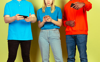 Image showing Group of friends using mobile smartphones. Teenagers addiction to new technology trends. Close up.