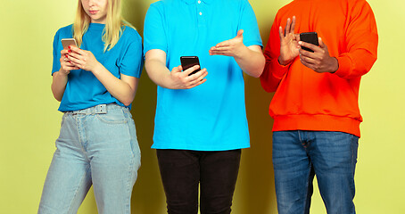 Image showing Group of friends using mobile smartphones. Teenagers addiction to new technology trends. Close up.