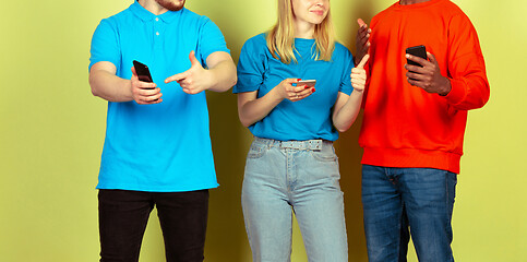 Image showing Group of friends using mobile smartphones. Teenagers addiction to new technology trends. Close up.