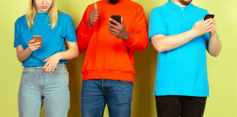 Image showing Group of friends using mobile smartphones. Teenagers addiction to new technology trends. Close up.