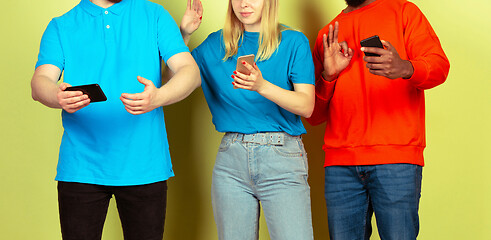 Image showing Group of friends using mobile smartphones. Teenagers addiction to new technology trends. Close up.