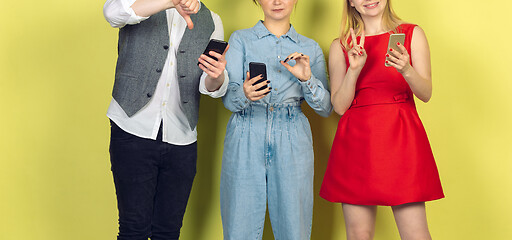 Image showing Group of friends using mobile smartphones. Teenagers addiction to new technology trends. Close up.