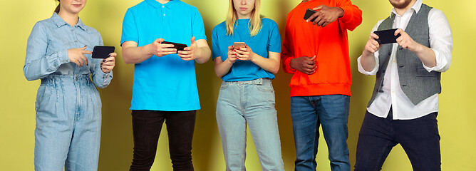 Image showing Group of friends using mobile smartphones. Teenagers addiction to new technology trends. Close up.