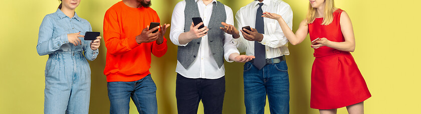 Image showing Group of friends using mobile smartphones. Teenagers addiction to new technology trends. Close up.