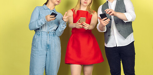 Image showing Group of friends using mobile smartphones. Teenagers addiction to new technology trends. Close up.
