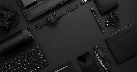 Image showing Business concept. Flat lay composition with various black gadgets on dark black surface