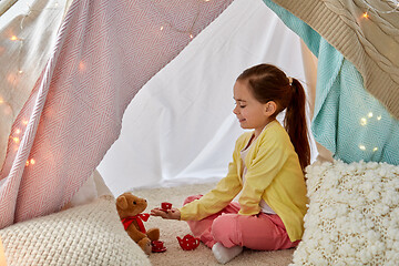 Image showing girl playing tea party with teddy in kids tent