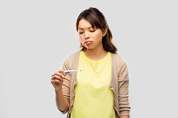 Image showing sick asian woman with thermometer having fever