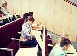 Image showing group of students with notebooks at lecture hall